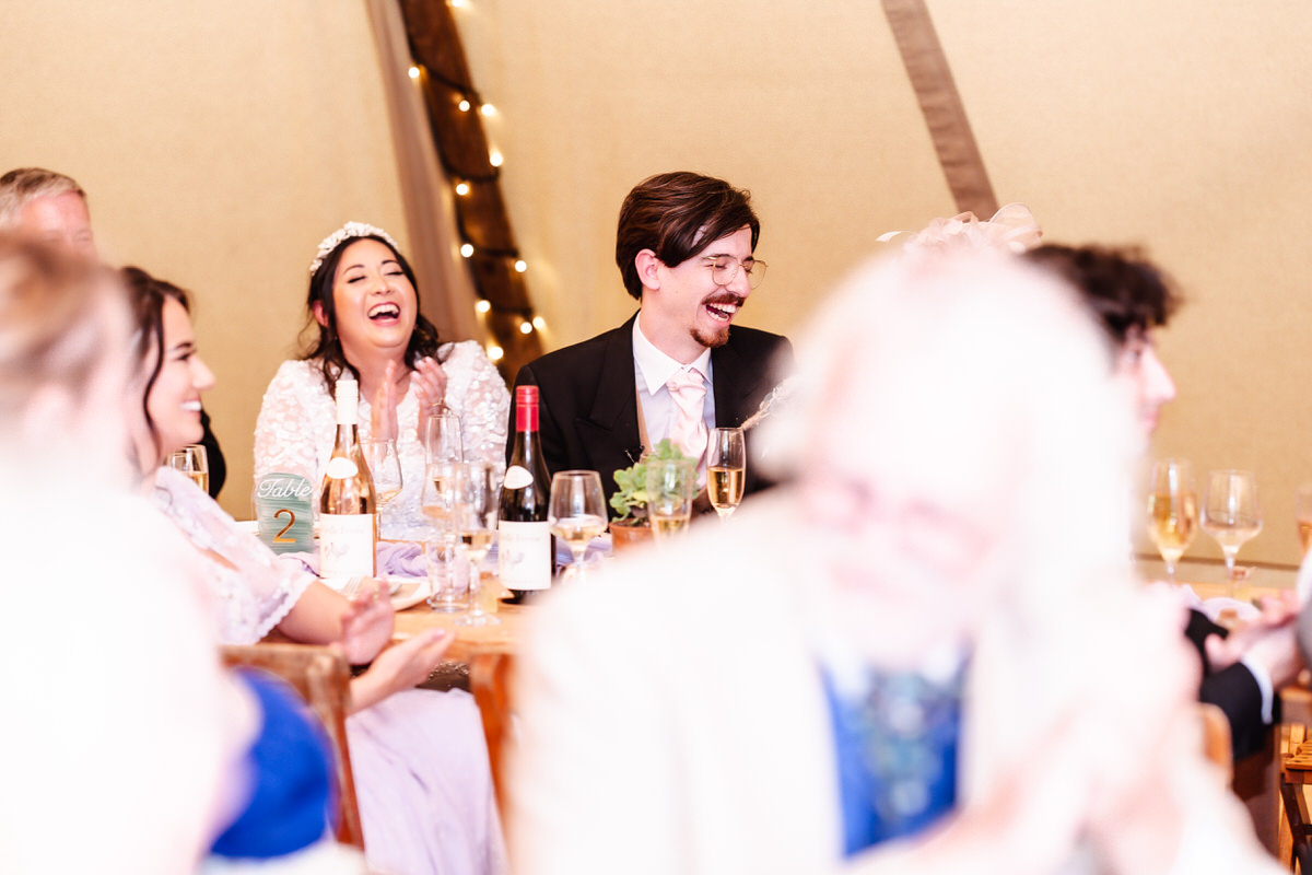 bride and groom laughing during the wedding speech