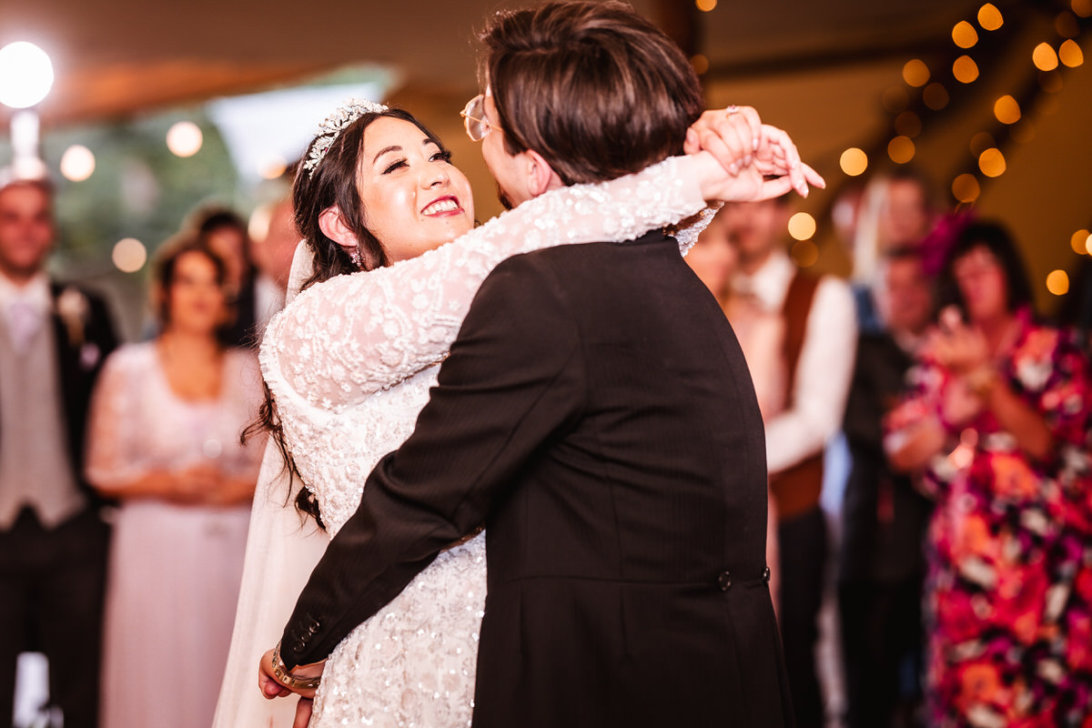 natural and candid photo of bride and groom dancing together