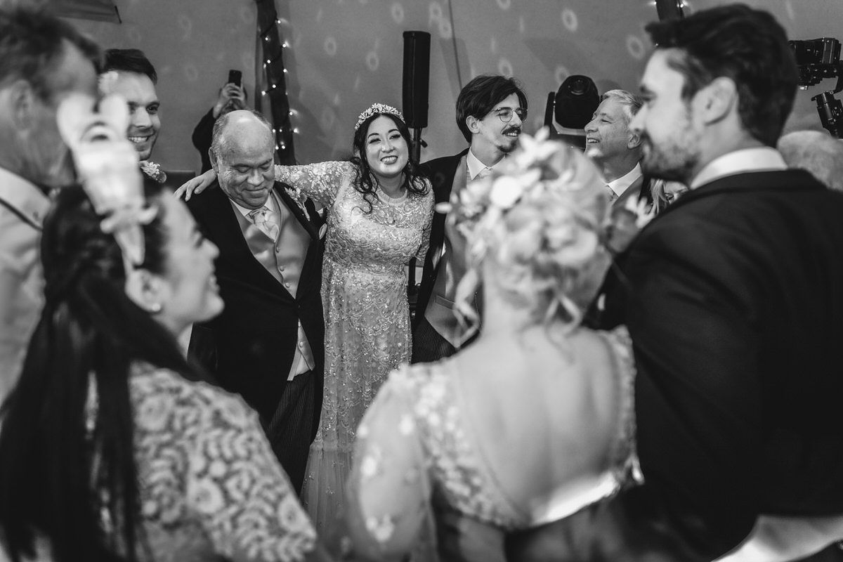 black and white photo of bride and groom dancing