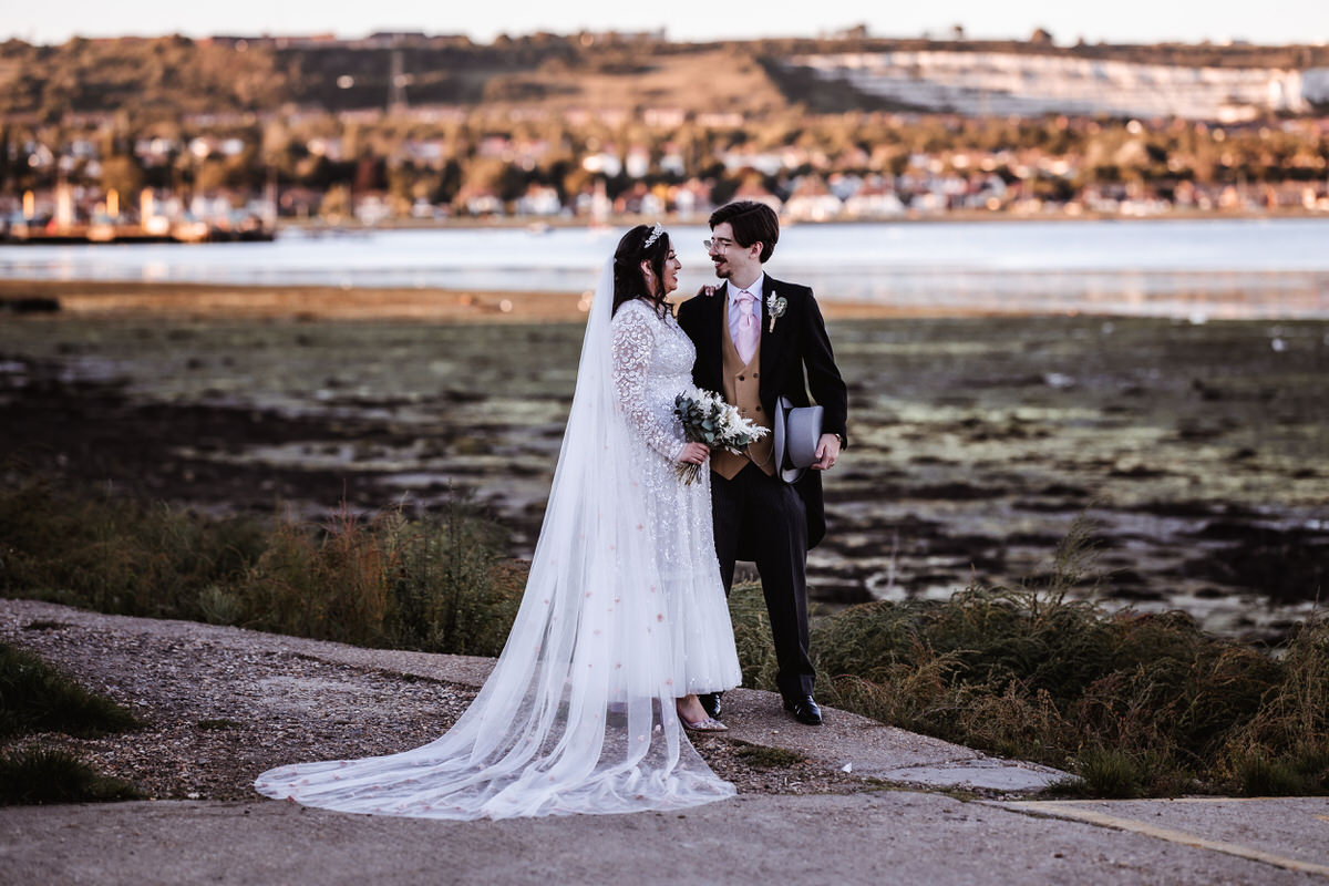 bride and groom by the beach in Porchester