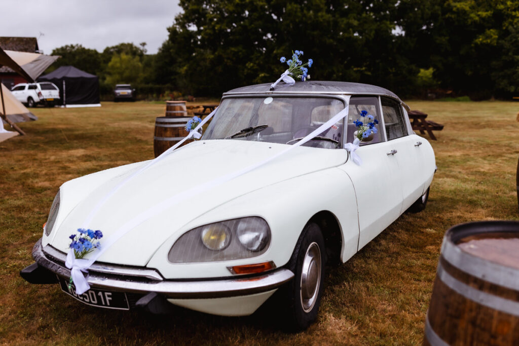 A white car with flowers on it.