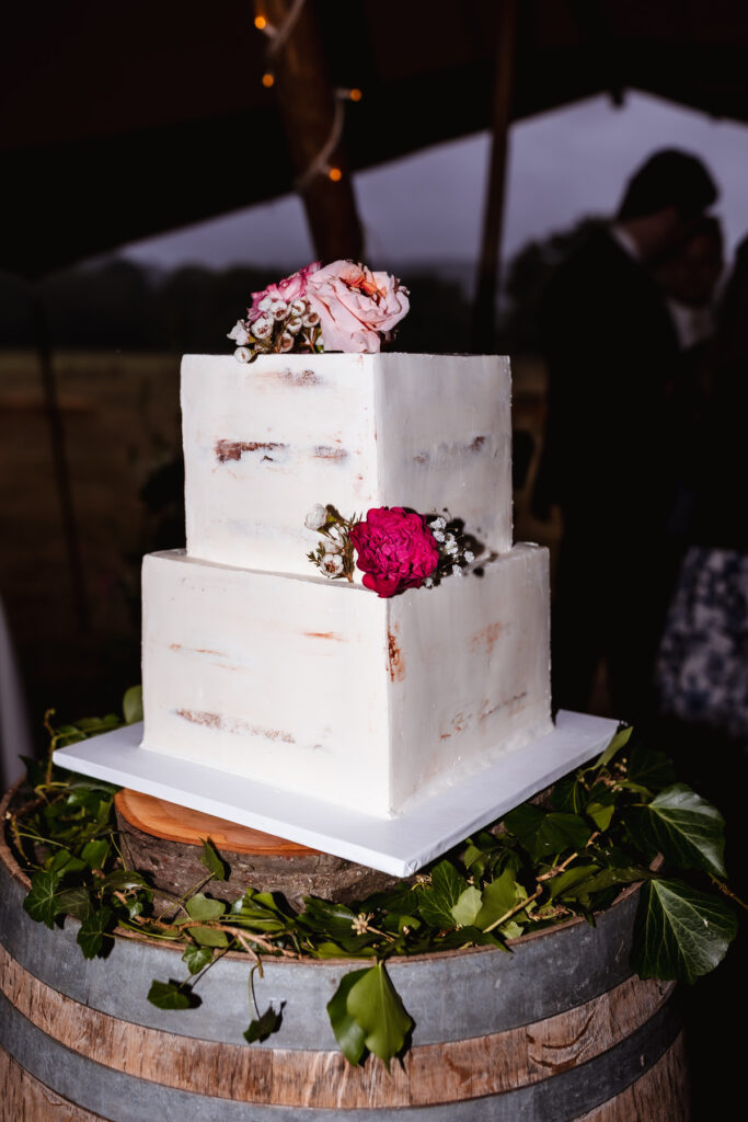 A white cake with flowers on top.